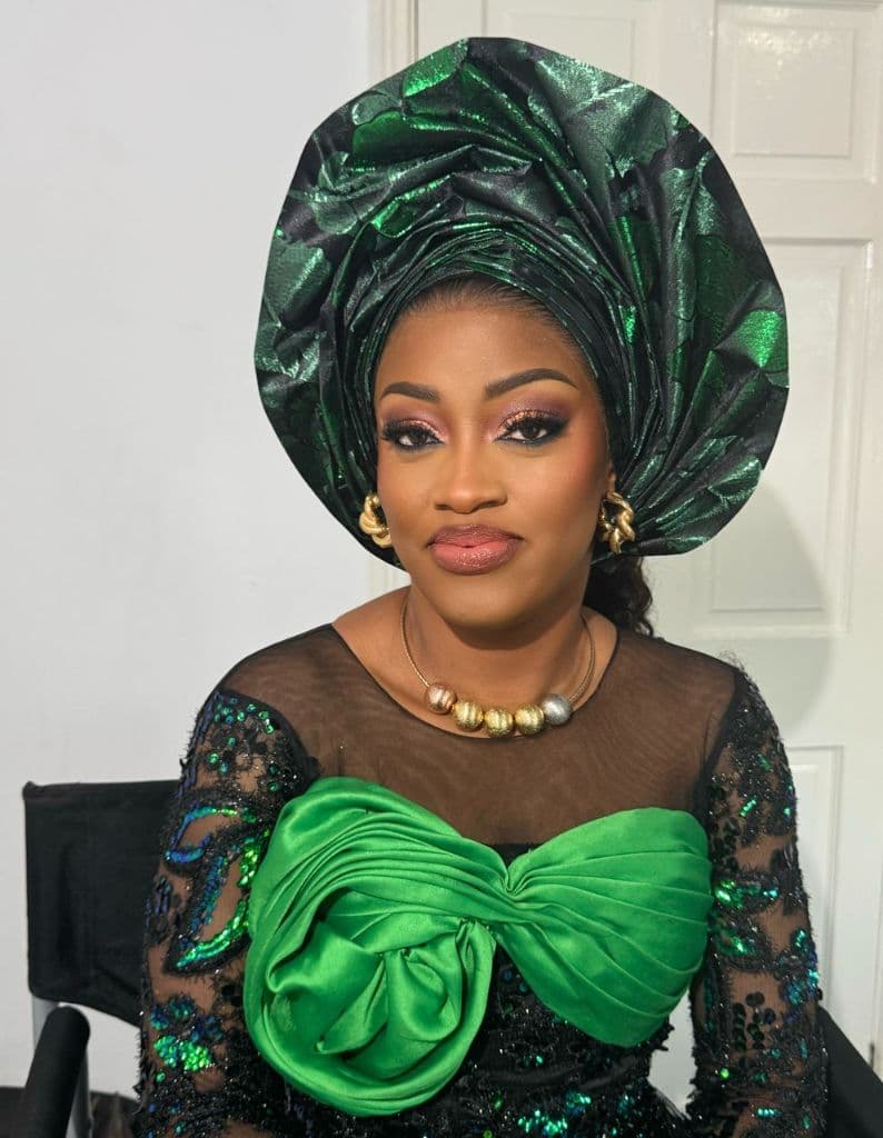Bridal-ready glam with an emerald green Gele headtie and matching lace outfit